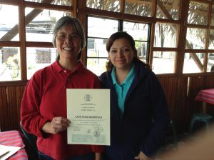 Cayatana Maristela pictured with her Spanish-language teacher, Carolina Molina, showing offer her Spanish-language certificate.