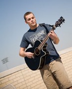 Andrew Payeur, a first-year School of Law student, practices guitar at his favorite Kansas City hangout -- the Student Union rooftop.