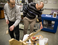 Professors Michael Kruger and Jerzy Wrobel demonstrate how gravity works by rolling a car on a track. This is just one of many principes tested in the lab.