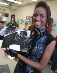 Marissa Hartman, a PREP-KC participant, displays the photogram she created.