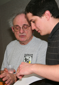 Professor Falls and former student Daniel Green review notes before the start of the 2010 History Bowl.