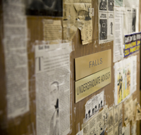 A variety of newspaper clippings, cartoons and notes cover Professor Falls' door.