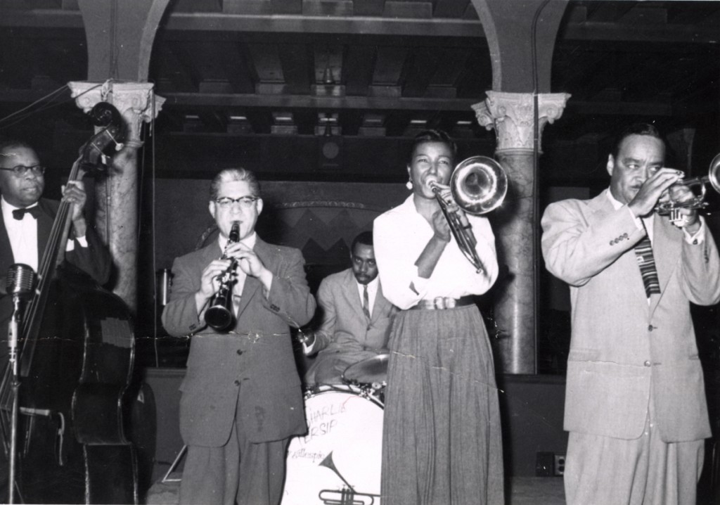Walter Page, Charlie Persip, Buck Clayton, Melba Liston, and an unidentified musician performing on stage. Photo Courtesy: The Buck Clayton Collection, LaBudde Special Collections.