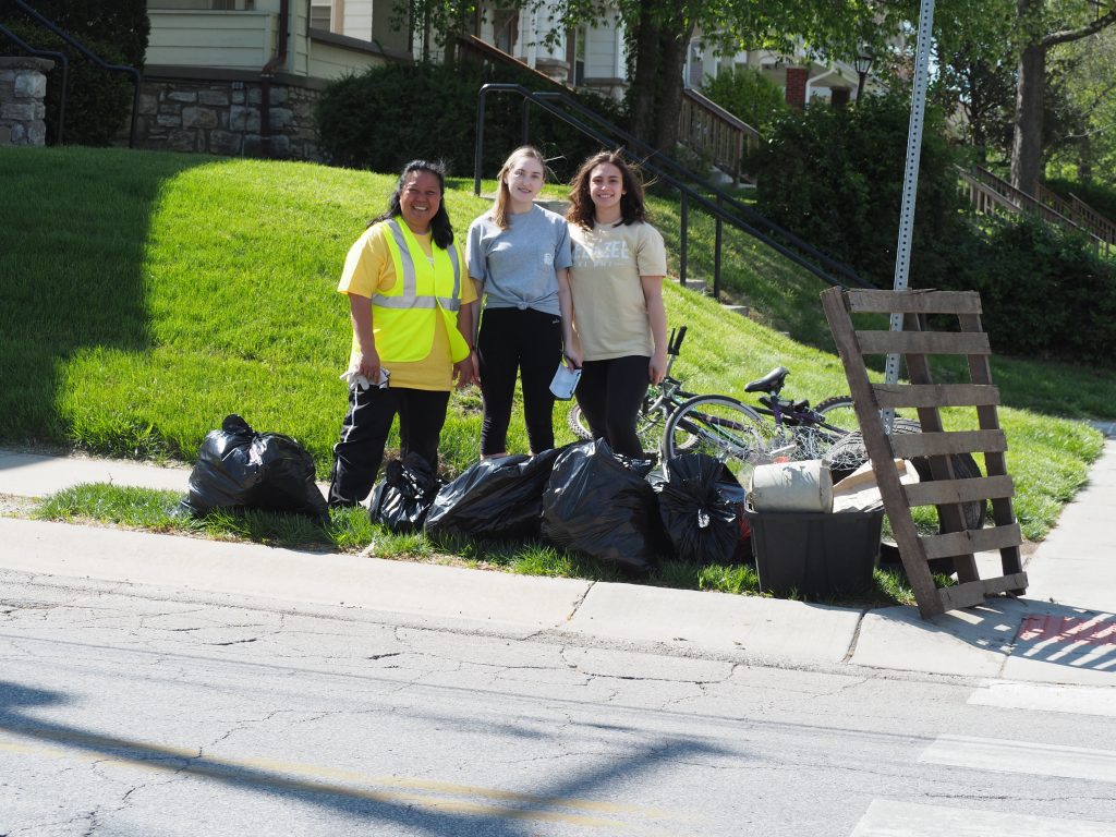 Volunteers pose after working hard to collect garbage.