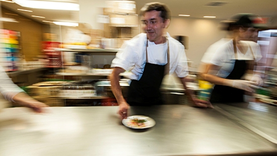 Ted Habiger rushes a salad plate to servers.