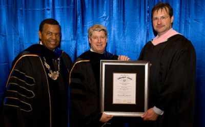Kansas City Symphony Music Director Michael Stern (center) stands with UMKC Chancellor Leo E. Morton (left) and UMKC Conservatory of Music and Dance Dean Peter Witte (right) after receiving an honorary doctorate from the UMKC Conservatory of Music and Dance.