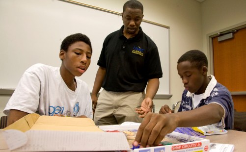 Clement Lumanyika, a senior Electrical and Computer Engineering major, teaches middle school students from the Kansas City, Missouri School District how to build a circuit at KCP&L's Get Into Energy Camp.