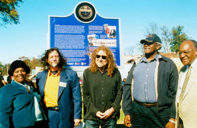Key figures in the Mississippi Blues Trail project, which was aided by UMKC's Marr Sound Archives, stand near the Tutwiler Blues Trail marker. From left are Tutwiler Mayor Genether Miller-Spurlock; Blues Trail research chairman Jim O'Neal; rock superstar Robert Plant; former Tutwiler Mayor Robert Grayson; and state Sen. David Jordan. Photo by Panny Flautt Mayfield.