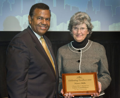 Chancellor Leo Morton presents Nancy Mills with the Chancellor's Award for Career Contributions to the University.