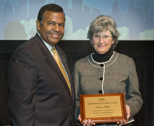 Chancellor Leo Morton presents Nancy Mills with the Chancellor's Award for Career Contributions to the University.