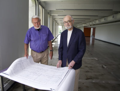Tom Nelson, FAIA and BNIM principal, and Ted Seligson, FAIA and visiting professor at AUPD, stand with the original 1965 blueprint of Katz Hall -- designed by Kivett & Myers, one of Kansas City's most prominent mid-century architectural firms. In the 1960s, Nelson worked on the Katz Hall designs and Seligson served as the head of design for Kivett & Myers.