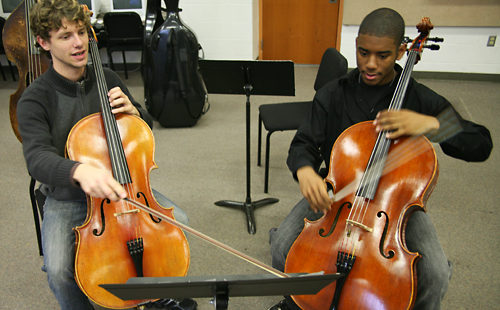 Mark Stauffer (left) gives instruction during a recent practice session with one of his Musical Bridges students.
