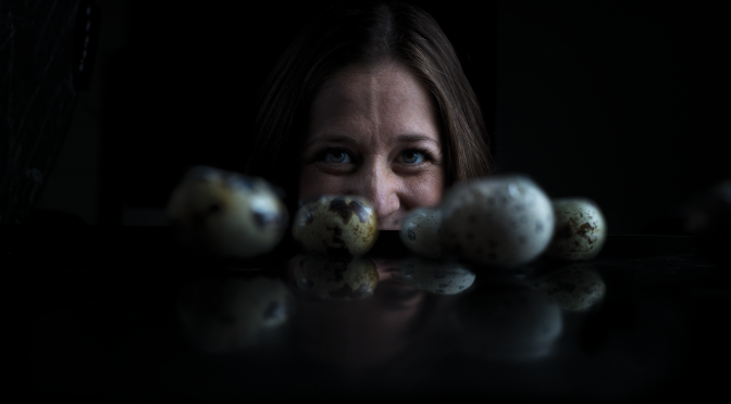 Photo of Erin Bumann with some of the eggs she uses in her research